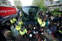 Police try to stop protesters forming a blockade around a coach in Peckham (Yui Mok/PA)