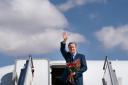 Foreign Secretary Lord David Cameron waves as he boards his plane in Ulaanbaatar, Mongolia, on the last day of his five day tour of the Central Asia region (Stefan Rousseau/PA)