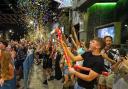 People celebrating the end of Covid rules at midnight while queueing outside a bar. Photo PA