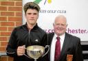 WELL DONE: Jack Garnett receives the Charity Cup from Five Lakes club captain Roger Hyman.