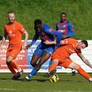 Battle - Maldon and Tiptree's Samuel Ayoola tussles for possession against Lowestoft Town. Picture: ROY WARNER