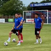 Game time - Noah Chilvers and his Colchester United team-mates warm up prior to their friendly against Maldon and Tiptree