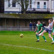 Strike: Maldon and Tiptree's George Smith fires towards goal during his side's defeat at Gorleston.