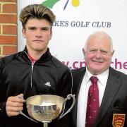 WELL DONE: Jack Garnett receives the Charity Cup from Five Lakes club captain Roger Hyman.