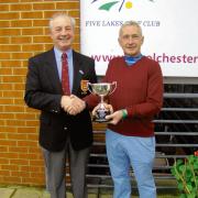 CONGRATULATIONS: Frank Taylor is presented with the Hangover Cup from club captain Nigel Popper.