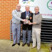 WINNERS: Neil Shinwell and Frank Taylor receive the Perry Trophy from Five Lakes club captain Nigel Popper.
