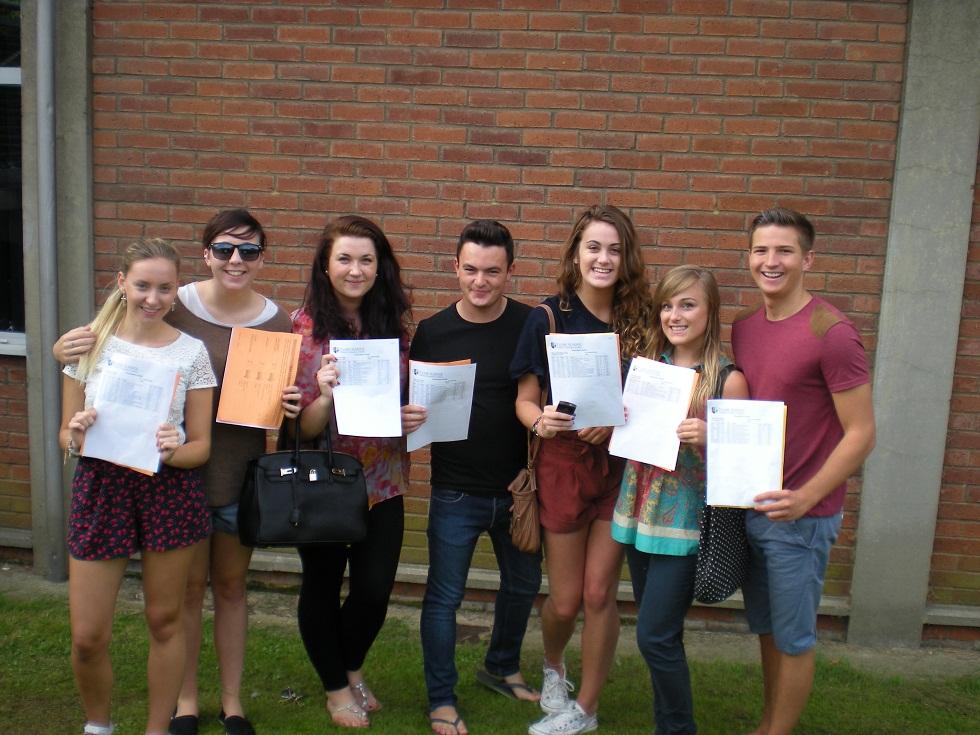 L to R: Charli Nixon, Holly Taylor, Amy Kemsley, Charlie Goss, Georgia-May Collings, Sophie Taylor and Ben Knights with their A-level results at Plume School.