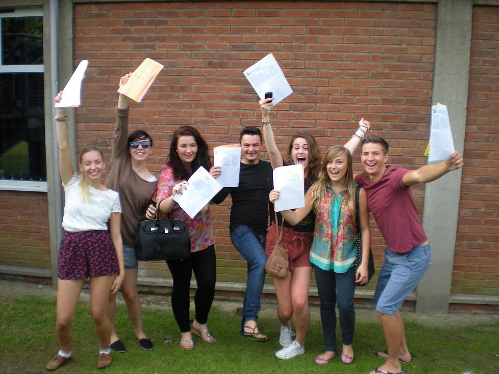 L to R: Charli Nixon, Holly Taylor, Amy Kemsley, Charlie Goss, Georgia-May Collings, Sophie Taylor and Ben Knights with their A-level results at Plume School.