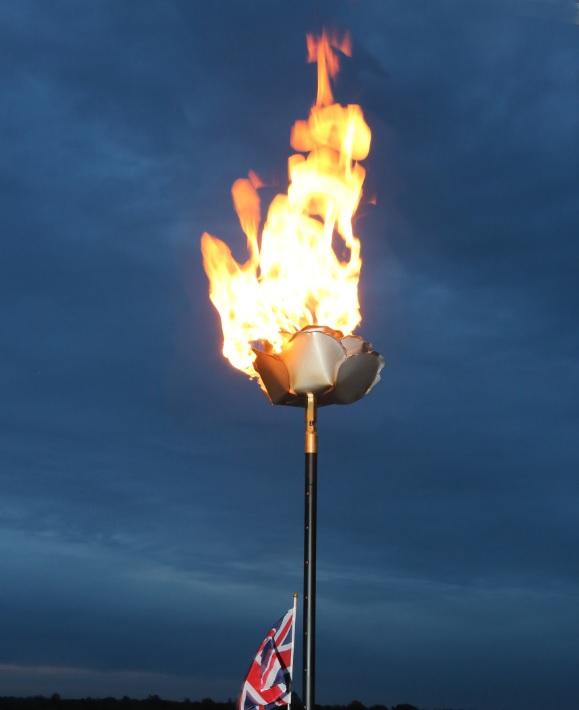 The specially designed rose beacon burns in Promenade Park