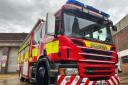 Firefighters battle inferno after outbuilding goes up in flames near houses