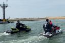 Communication: Sergeant Alex Southgate speaking with a pair of personal watercraft riders