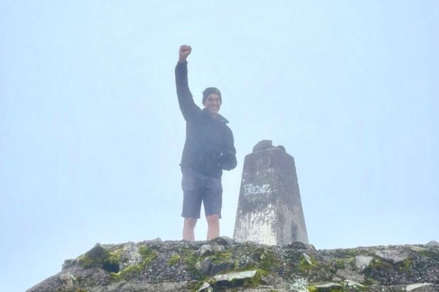 Trevor Botwood at the top of Ben Nevis. See SWNS story SWTPnevis. A dad who suffered a heart attack while climbing Ben Nevis has finally conquered the peak - alongside the woman who saved his life on the first attempt.Trevor Botwood was climbing the