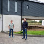 Self-builder Geoff Wood and TV host Kevin McCloud outside the Grand Designs 'floating' home beside the Blackwater Estuary. Photo: Channel 4