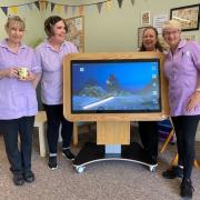 Knightswood Day Centre staff with its new 'Tiny' tablet