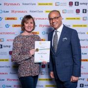 Justine Page accepting her small business award certificate from initiative founder Theo Paphitis, famous for Dragons' Den appearances