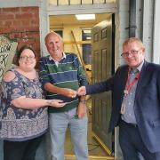 Maldon CVS director Sarah Troop and shed member Bob Adams accept the keys for the shed from Alan Whyld at Southminster station. Credit: Maldon & District CVS