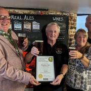 James Burrell-Cook presents the award to John Boyce and Gill Crawford, with Mighty Oak CAMRA brewery liaison officer Mark Ellis
