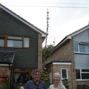 Stephen and Jayne Hill with the hollyhock which towers over their garden