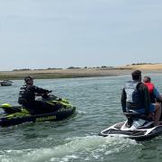Communication: Sergeant Alex Southgate speaking with a pair of personal watercraft riders