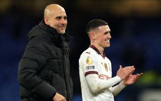 Manchester City manager Pep Guardiola with in-form Phil Foden (Martin Rickett/PA)